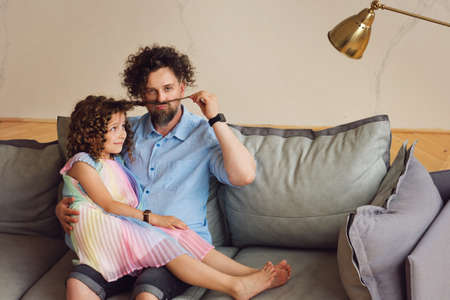 Portrait Young Friendly Family. Father and daughter relaxing in sofa. Family Time Together. Daddy...