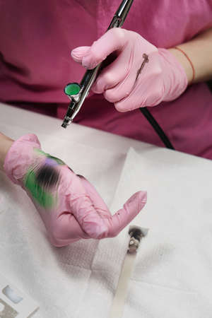 Manicure Master Mixes Paints in Airbrush Before Spraying. New Hobby Creative Creativityの写真素材