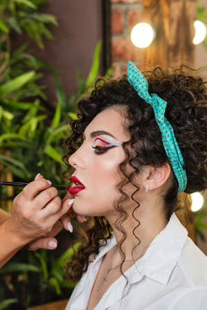 Makeup artist working with model in beauty salon. Perfect skin facial. Beautiful fashion luxury...