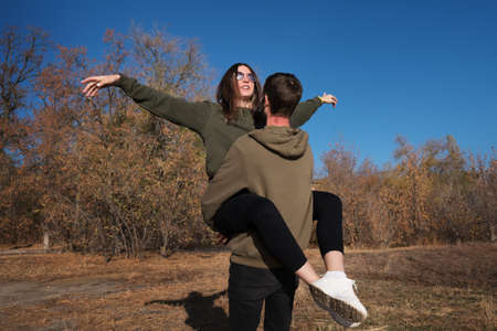 Happy Young Couple Walking And Having Fun In Autumn Park. Love Story. Love Spending Time Together....