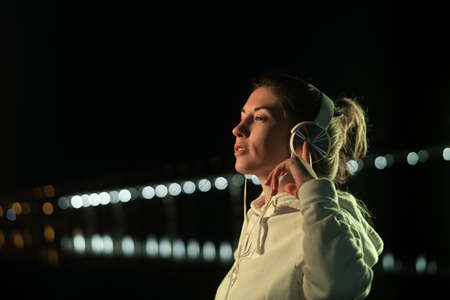 Millennial Girl Enjoying Nightlife In City Street. Listening Music With Headphones. Gorgeous Hipster...