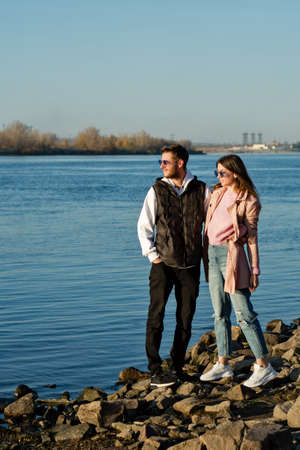 Full-length portrait of couple of tourists travelers in love. Newlyweds are enjoying sunny day on...