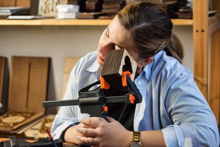 Tired craftsman while working in handmade carpentry workshop. Master has deadline. Large order for...