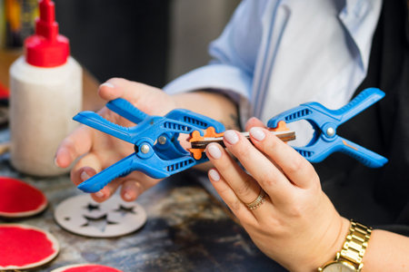 Closeup process making handmade wooden Christmas toys in carpentry woodworking workshop. Eco...