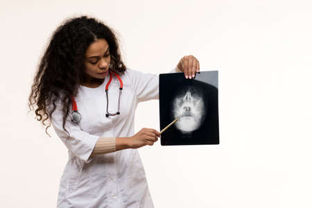 African American Female Pediatrician with Digital Tablet and Happy Girl Patient on Light background....