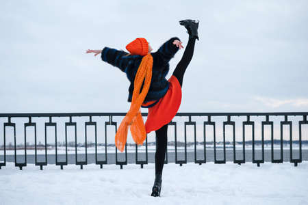 Portrait Attractive Girl Walking in Winter Park. Young Woman in Stylish Warm Outfit and Orange...