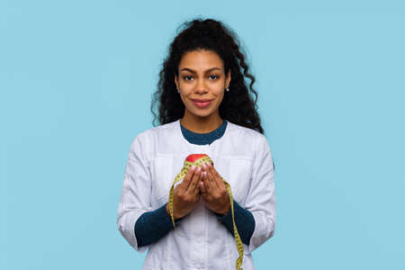 Friendly African American Female Physician Medical Advisor Shows Heart Gesture with Two Hands on...