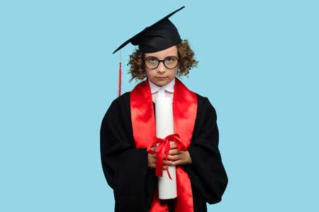 Pleasant curly short-haired female child girl 10-12 years old wears red basic t-shirt. Kind-hearted preteen schoolgirl made heart shape from two palms against chest on white background studio.の写真素材