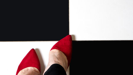 Selfie feet wears classic shoes court shoe on checkered floor background. Image legs in red velvet shoes pumps on black and white floor. top viewの写真素材