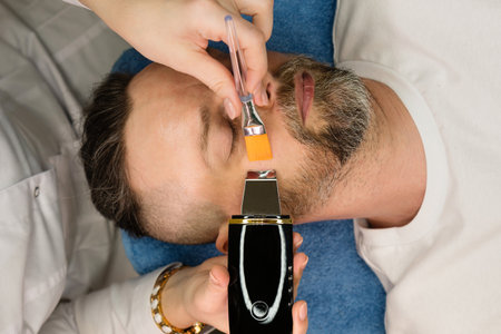 Man getting ultrasound facial peeling in spa salon