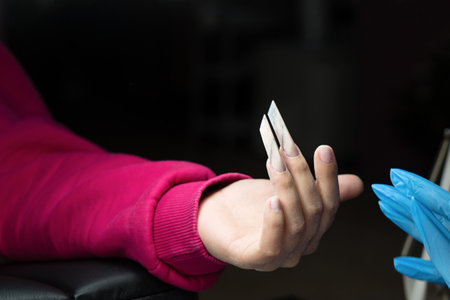 Final touches applied to edge nail manicure.の写真素材