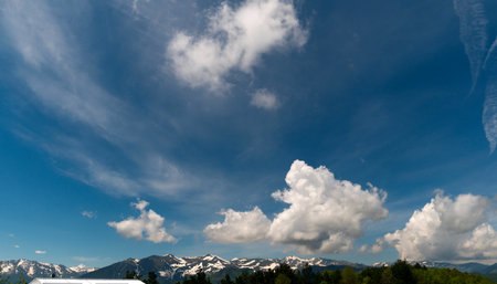 Snowy mountains under a partly cloudy sky.の写真素材