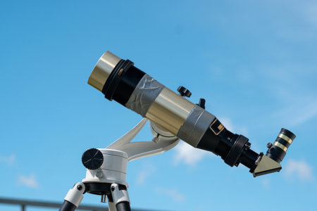 Single solar telescope against a clear blue sky.