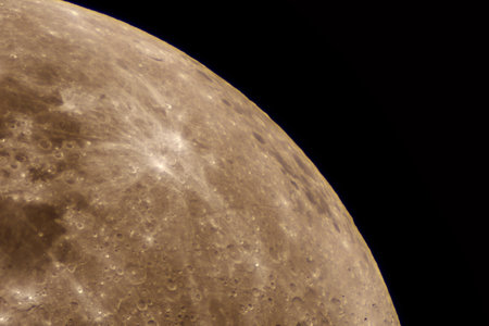 Partial lunar sphere revealing bright radial marks on cratered surfaceの写真素材