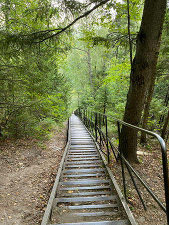 Climbing the mountain Dvuglavaya sopka from the White Key shelter. Stairs are made to climb almost to the very top, so that it is easier for people to walk. Taganay national Park. Zlatoust city.の写真素材
