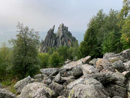 Descent from the mountain Dvuglavaya sopka. View of the Climbing Wall with rocks look like feathers. Taganay national Park. Zlatoust city. Chelyabinsk region. South Ural. Russia.の写真素材