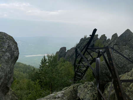 Dvuglavaya sopka. View of the broken power line support and the rocks that look like feathers. From the top there is a view of the Kamennaya river and the Sredny Taganay mountain.の写真素材