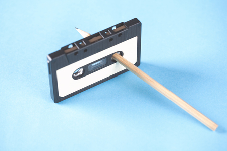 cassette and pencils  on blue table backgroundの写真素材