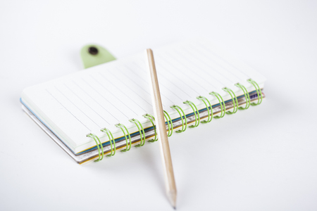notepad with pencil on white table backgroundの写真素材