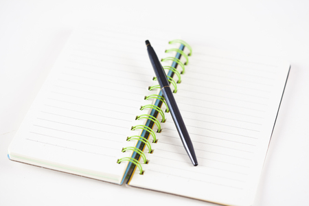 notepad with pen on white table backgroundの写真素材