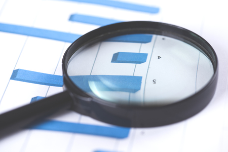 magnifier on the finance graph paper backgroundの写真素材