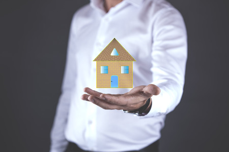 young man hand house  model in screenの写真素材