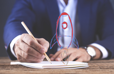 man hand pencil with notepad and racket in screenの写真素材