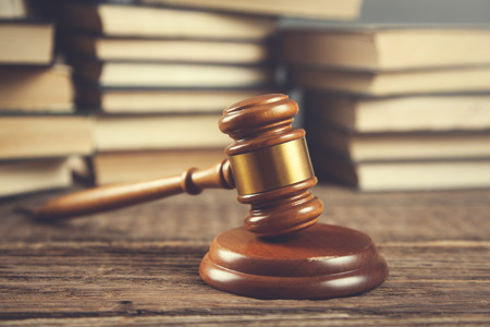 judge with books on the wooden table backgroundの写真素材