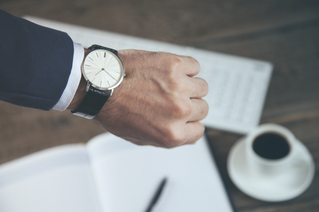 young man hand watch on working tableの写真素材