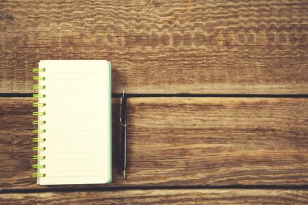pen with notepad on the wooden  table