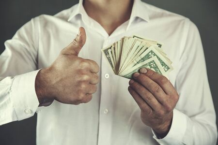 young business man hand money and okay signの写真素材