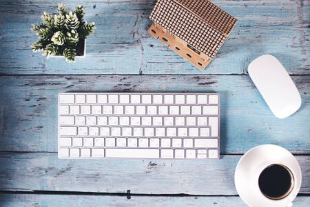 house model with keyboard and coffee on table