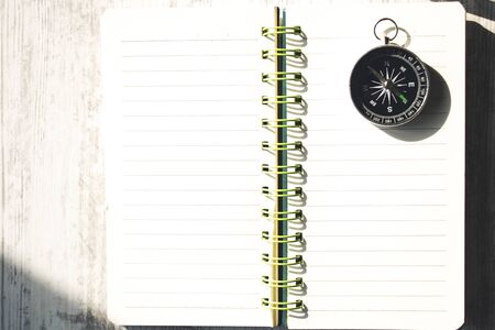 compass on notepad on the wooden tableの写真素材