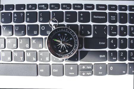 compass on the computer keyboard on table