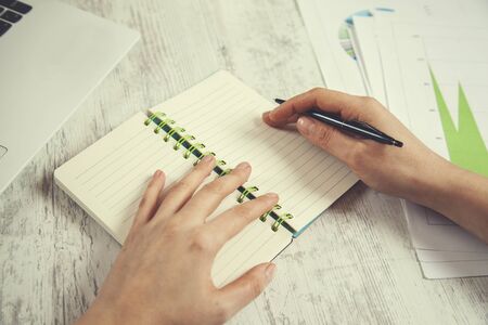 woman hand notepad with keyboard on table