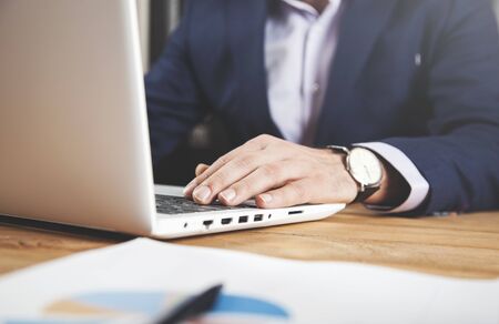 man working in computer with graph in office