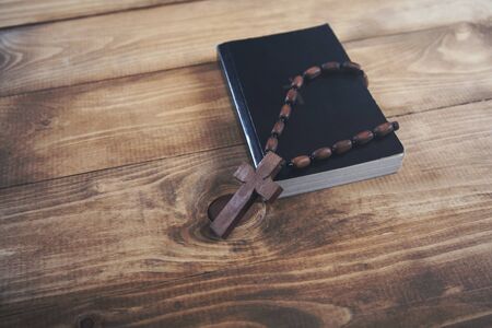 cross on book on the wooden backgroundの写真素材