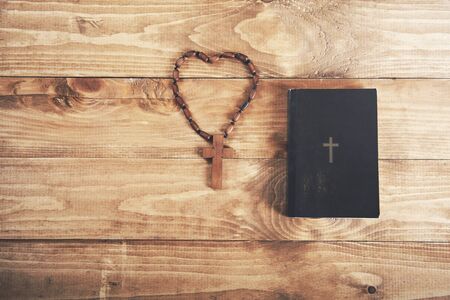 cross on book on the wooden backgroundの写真素材