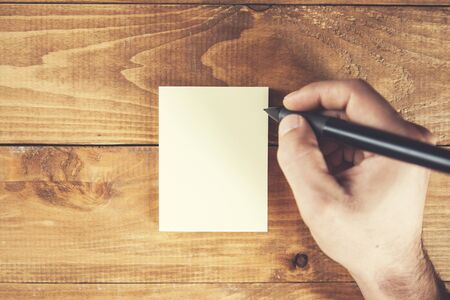 businessman showing card with pen on table