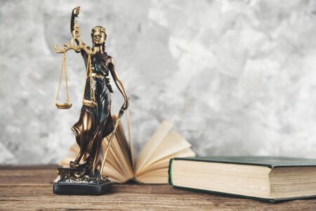 book with justice lady on table on gray background