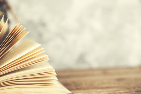 books page on wooden table with gray background