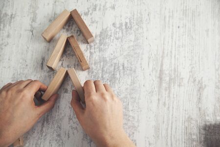 woman hand wooden cubes on the  table