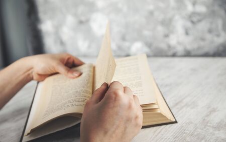 woman hand book on the wooden table