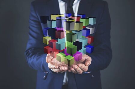 Cropped image of man  presenting multiple cubes in hands