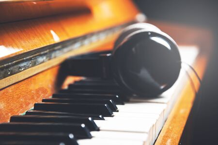 on the keyboard of the piano are headphonesの写真素材