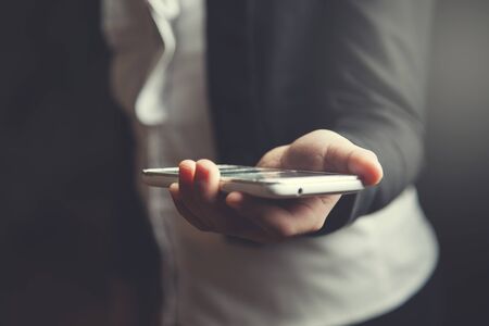 girl hand holding smart phone in home