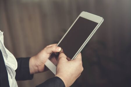 girl hand holding white tablet in homeの写真素材