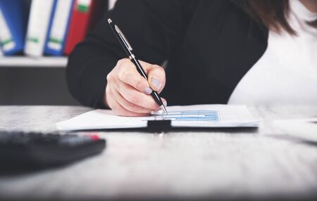 woman hand graph on the working desk