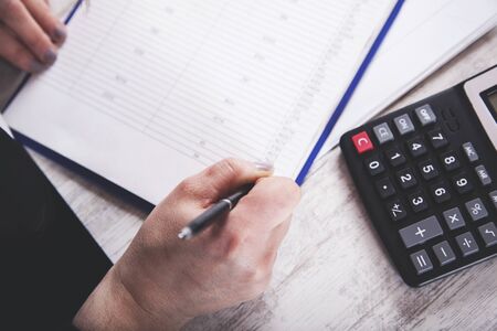 woman hand documents with calculator on deskの写真素材