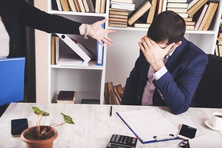 angry woman boss with man worker on deskの写真素材